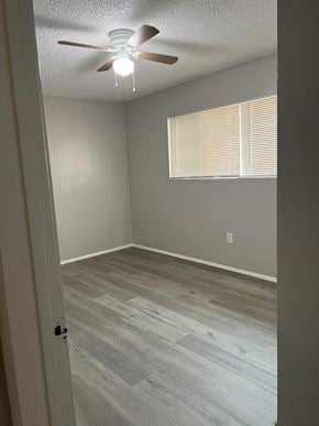 Calimesa apartment for rent - an empty room with a ceiling fan and a window