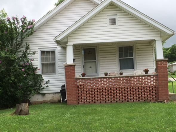 Windsor house for rent - the front of a white house with a brick fence