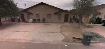Laredo house for rent - a house with an empty driveway in front of it