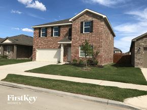 Ft. Worth house for rent - a brick house with a white garage door and a lawn