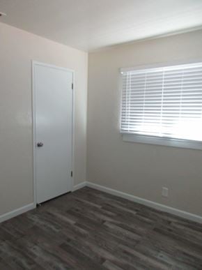Patterson house for rent - A room with a white door and a window with blinds.