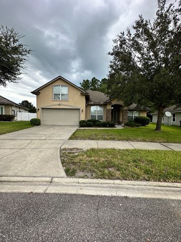 Jacksonville house for rent - a house on a street with a cloudy sky
