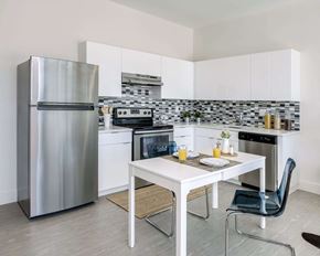 Tampa apartment for rent - a kitchen with a table and a refrigerator