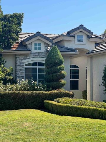 Fresno house for rent - a house with a yard and a tree in front of it