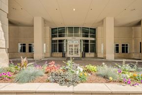 Denver apartment for rent - the entrance to a building with a garden in front of it