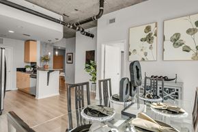 Denver apartment for rent - a dining room with a glass table and chairs
