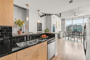 Denver apartment for rent - a kitchen with a sink and a window and a dining room