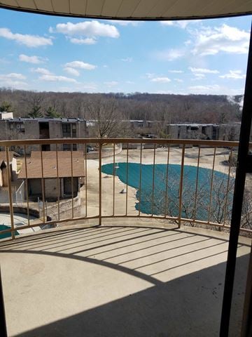 Temple Hills house for rent - A balcony with a pool and trees in the background.