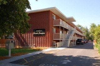 Provo apartment for rent - a large brick building with a sign on the side of it