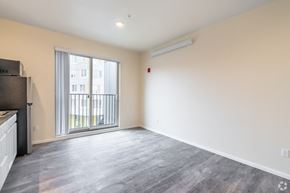 Seattle apartment for rent - an empty living room with a large window and a balcony