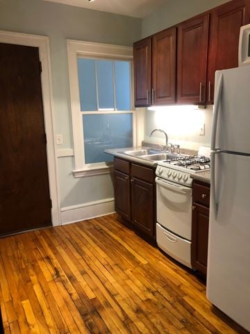 Minneapolis apartment for rent - an empty kitchen with wood floors and white appliances