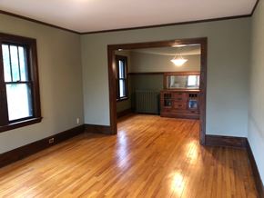 Minneapolis apartment for rent - an empty living room with wooden floors and a window