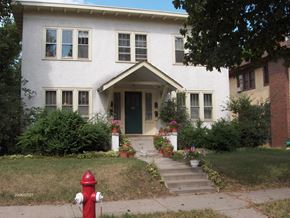 Minneapolis apartment for rent - a white house with a red fire hydrant in front
