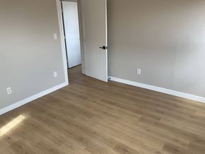 Los Angeles apartment for rent - a living room with wood flooring and white walls and a door