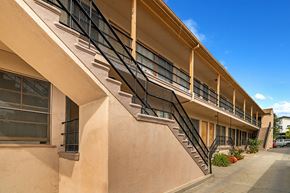 Los Angeles apartment for rent - an exterior view of a building with a staircase on the side