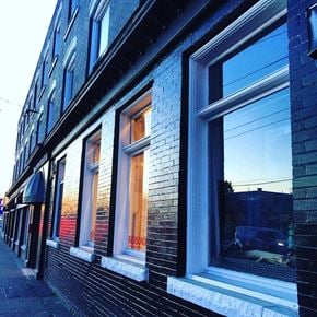 Vancouver apartment for rent - A building with windows and a sign that says "Ribson".