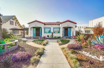 Los Angeles apartment for rent - A small house with a red tile roof and a blue door.