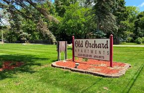 Holt apartment for rent - a sign for old orchard apartments in a park