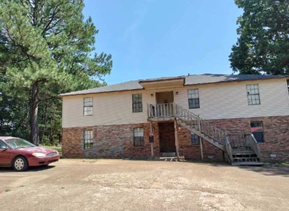 Lexington apartment for rent - a house with a red car parked in front of it