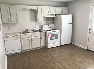 Wildersville apartment for rent - a kitchen with white appliances and a sink and a refrigerator