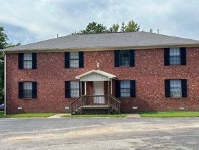 Lexington apartment for rent - the front of a red brick building with a porch