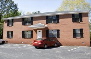Lexington apartment for rent - a red car parked in front of a brick building