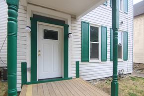 Pittsburgh house for rent - A white door with green trim is on the front porch of a house.