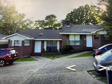 Hattiesburg apartment for rent - A house with a red car and a silver car parked in front.