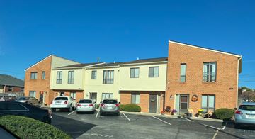 Roaonke apartment for rent - A parking lot in front of a two-story building with cars parked.