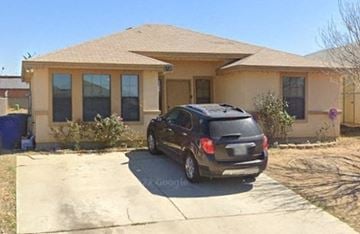 Laredo house for rent - a car parked in a driveway in front of a house
