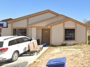 Laredo house for rent - a house with a car parked outside of it