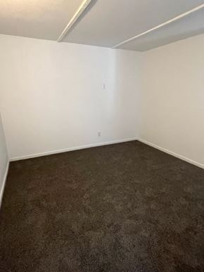 Avondale apartment for rent - an empty room with a brown carpet and white walls