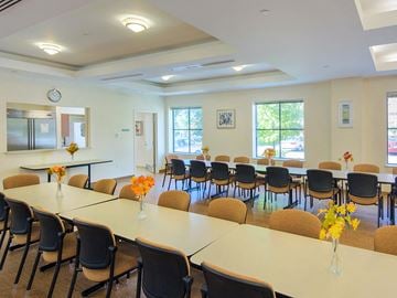 West Roxbury apartment for rent - a conference room with long tables and chairs and a kitchen
