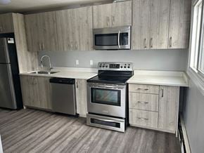 Edmonton apartment for rent - A kitchen with a stove, oven, microwave, and refrigerator.