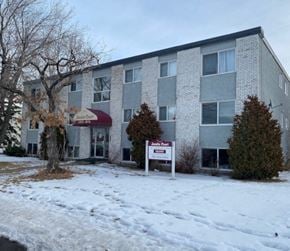 Edmonton apartment for rent - A building with a sign that says "Jamie Court" in front of it.