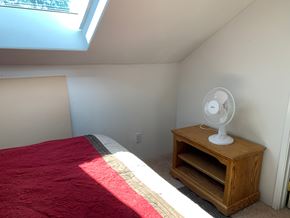 Hayfork apartment for rent - a small bedroom with a bed and a fan