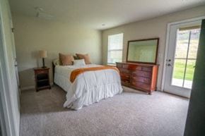 Tega Cay house for rent - a bedroom with a bed and a dresser and a window
