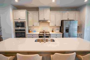 Tega Cay house for rent - a kitchen with white cabinets and a white counter top