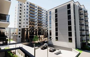 Kitchener apartment for rent - A modern apartment complex with cars parked in the driveway.