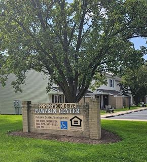 Hughesville apartment for rent - a sign for the is sherwood drive pumpkin center in front of a tree