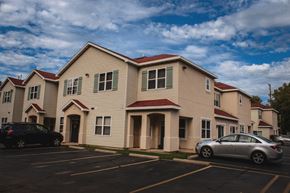 Oshkosh townhouse for rent - an apartment building with cars parked in front of it