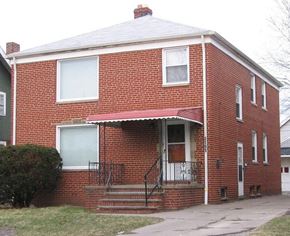 Cleveland apartment for rent - A red brick house with a white door and windows.