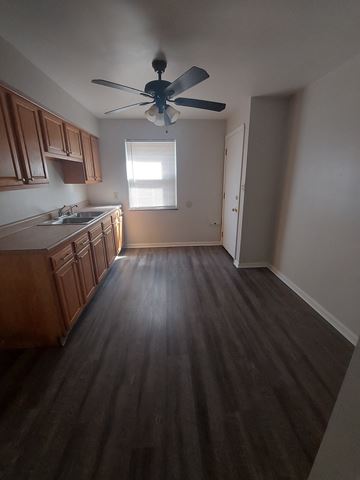 Cleveland apartment for rent - A kitchen with wooden cabinets and a ceiling fan.