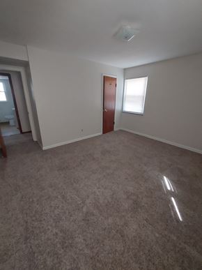 Cleveland apartment for rent - A room with a carpeted floor and a door.