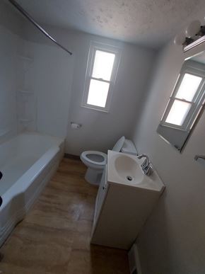 Cleveland apartment for rent - A bathroom with a toilet, sink, and bathtub.