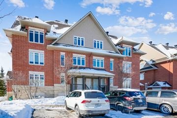 Stittsville apartment for rent - A red brick house with a white car parked in front.