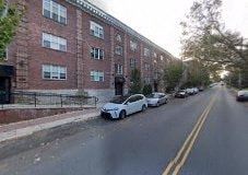 Philadelphia apartment for rent - a street with cars parked in front of a brick building