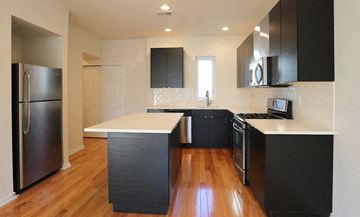 Philadelphia apartment for rent - a kitchen with black cabinets and a stainless steel refrigerator