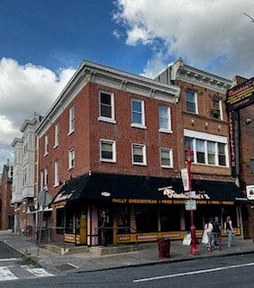 Philadelphia apartment for rent - a brick building on the corner of a city street