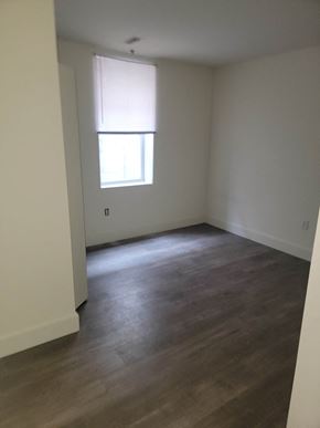 Philadelphia apartment for rent - an empty living room with wood floors and a window